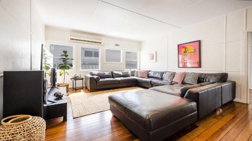 a large living room with a couch and a table at Leonards Beachshack - Lifestyle Yamba in Yamba