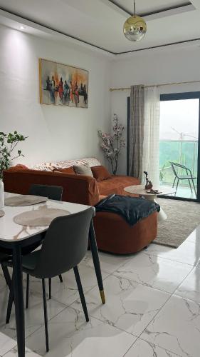 a living room with a couch and a table at Le Terracotta Panoramic View Bingerville in Bingerville