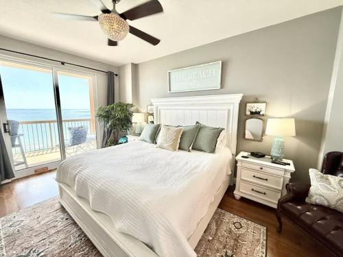a bedroom with a large bed with a view of the ocean at Blue Heron Beach Front in Panama City Beach
