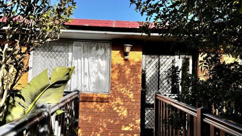 a house with a window and a fence at The Perch - Lifestyle Yamba in Yamba
