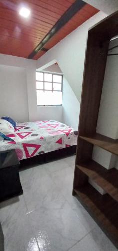 a bedroom with a bed in a room at Apartaestudio in Tocancipá