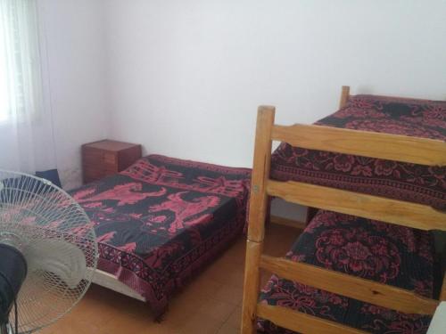 a room with two bunk beds and a fan at Rocio de Luna in Mina Clavero