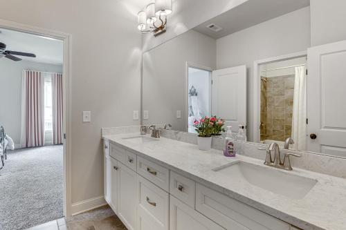 a bathroom with two sinks and a large mirror at Executive 5BR Stay in Duluth w/ Pool Access in Duluth