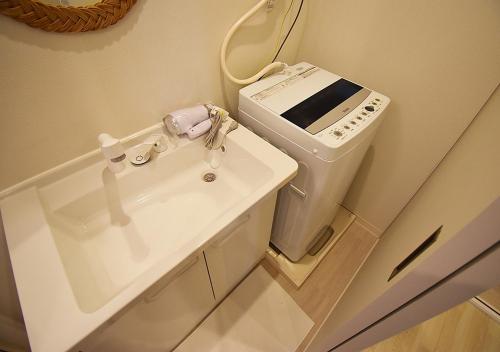 a bathroom with a sink and a washing machine at WAMARE Shibamata, Entire private two-story house, Traditional Tokyo Stay with Easy Access to Haneda & Narita Airports, up to 4pax in Tokyo