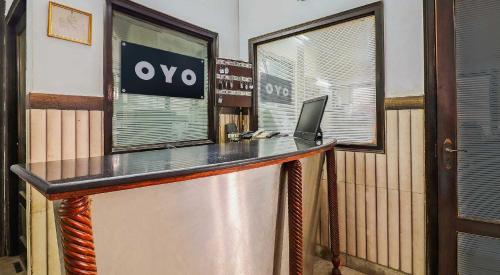 an office with a desk with a laptop on it at Hotel O Prem Chunaria in Morādābād