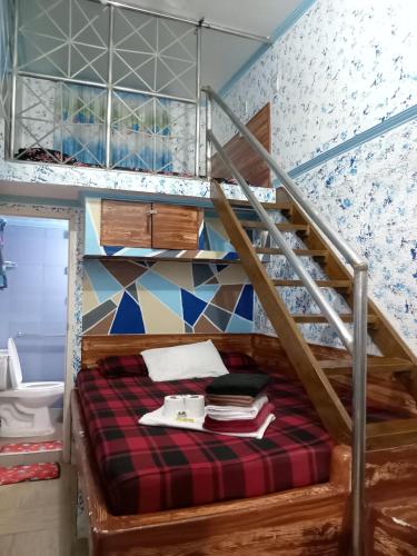 a bedroom with a bunk bed with a staircase at Daniela's Place in Angeles