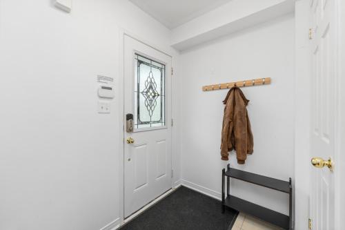 a hallway with a white door and a window at Semi-Private Townhouse - 3 Bedrooms, 4 beds, Free Parking, Wifi, Netflix, - Hosted by Matthew in Toronto