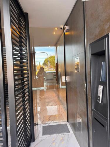 a glass door leading into a bathroom with a view at Hermoso departamento Saavedra 4741 in Buenos Aires