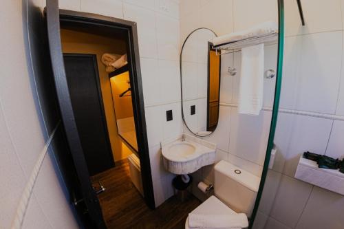 a small bathroom with a sink and a toilet at Zagat Classic Hotel in Foz do Iguaçu