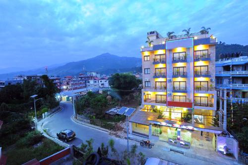 a building on a city street at night at Hotel Queens Park in Pokhara