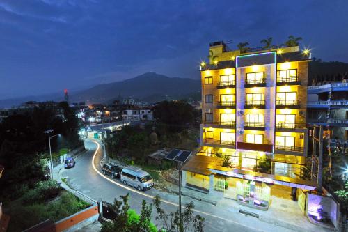 a building on a city street at night at Hotel Queens Park in Pokhara