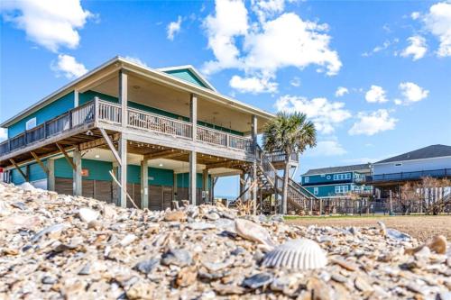 a house on the beach with a pile of rocks at Beachfront Fire Pit Gourmet Kitchen Views in Bolivar Peninsula