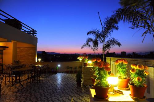 a view of a patio at night with lights at Hotel Queens Park in Pokhara