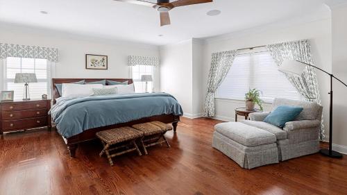 a bedroom with a bed and a couch and a chair at Welahpu Beach in Cape May