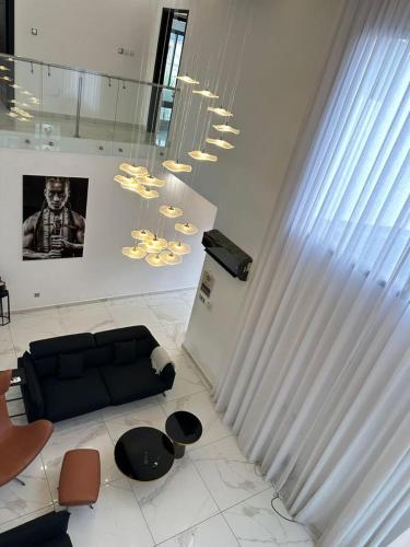 a living room with a couch and a chandelier at Villa 49 in Abidjan