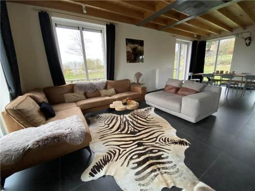 a living room with a zebra rug on the floor at Cosy Holiday Home in Durbuy with Garden in Durbuy