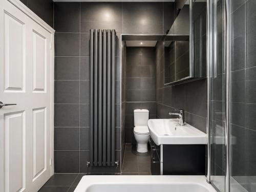 a bathroom with a toilet and a sink at Full House - Croydon centre in Croydon