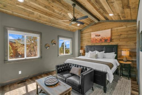a bedroom with a large bed and a chair at Sandstone Pointe, Elegance Among the Cliffs in Mount Carmel