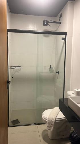 a bathroom with a shower and a toilet and a sink at Pousada do Francês in Ubatuba