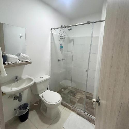 a bathroom with a shower and a toilet and a sink at Hotel Zona Oro in Armenia