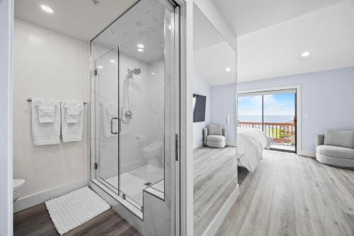 a white bathroom with a shower and a bedroom at Seascape Ocean View Condo in Aptos