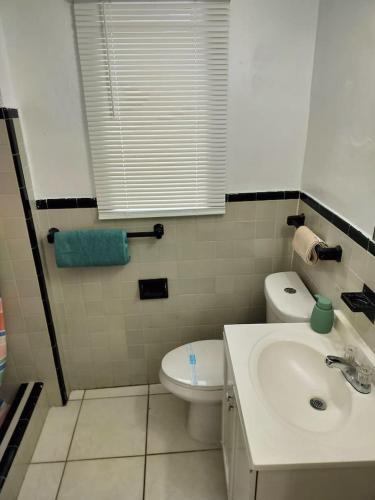 a bathroom with a white toilet and a sink at Modern studio in a prime location 112-1 in Hollywood