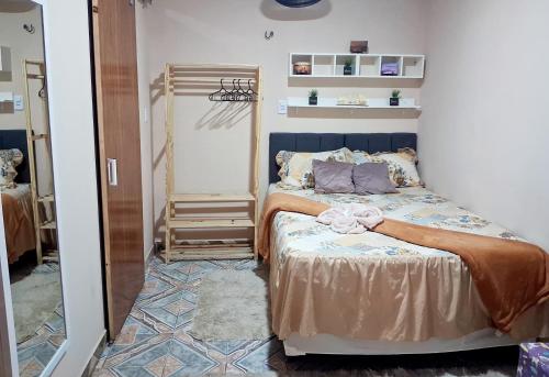 a bedroom with a bed with a bow on it at Hospedagem Aconchego do Lar in Barreirinhas