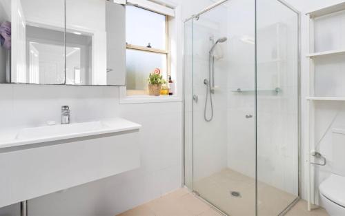 a bathroom with a shower and a sink at Ocean Tracks in Kiama
