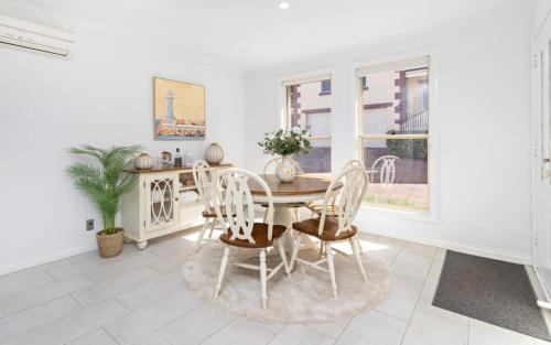 a dining room with a table and chairs at Ocean Tracks in Kiama