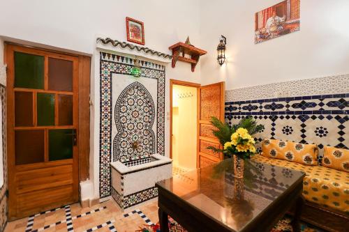 a living room with a couch and a table at Dar Houda in Fez