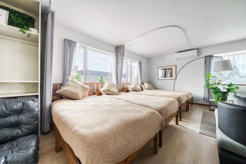 a bedroom with four beds in a room at Snowm in Asahikawa