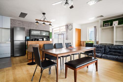 a kitchen and dining room with a table and chairs at Snowm in Asahikawa