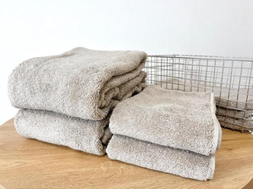 a pile of towels sitting on top of a table at 海しずく Slow in Amakusa