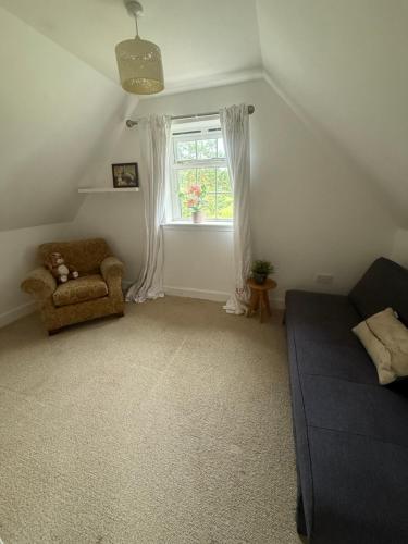 a living room with a couch and a window at Laimhrig Lockley in Torrin