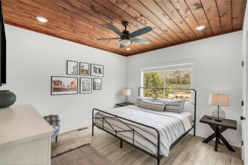 a bedroom with a bed and a ceiling fan at Painted Cliffs-Hot Tub, Amazing Views Between Zion and Bryce in Orderville