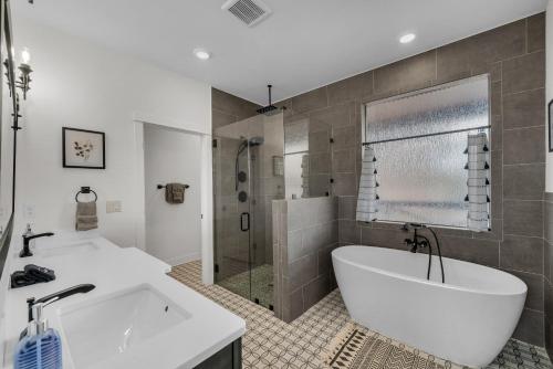 a bathroom with a tub and a sink and a shower at Copper Rock Ridge- Luxury, Pool Table, Hot Tub between Zion and Bryce in Orderville