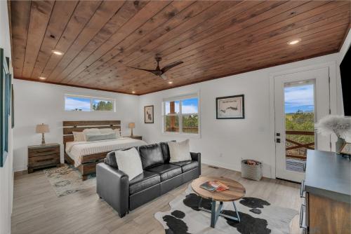 a living room with a couch and a bed at Copper Rock Ridge- Luxury, Pool Table, Hot Tub between Zion and Bryce in Orderville