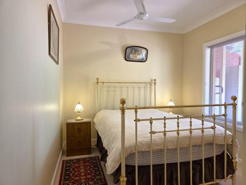 a bedroom with a bed and a window at Willenby in Wallaroo