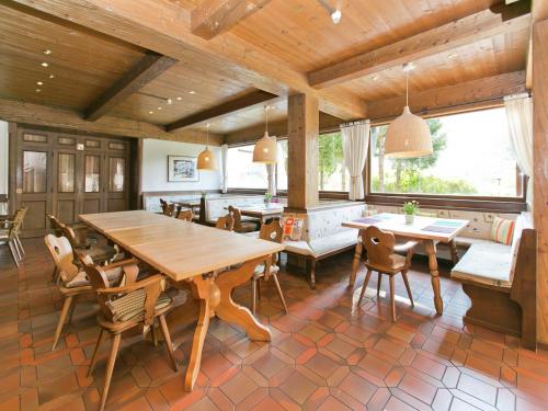 a dining room with a wooden table and chairs at Chalet in Angerberg near SkiWelt Slopes in Angerberg