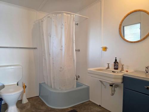 a bathroom with a shower and a sink and a toilet at Jack's Shack in Pine Point