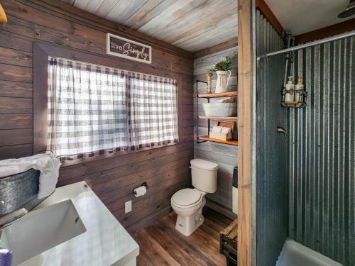 a bathroom with a toilet and a sink and a window at Live Simply Cabin, Walking distance to East Zion trails in Orderville