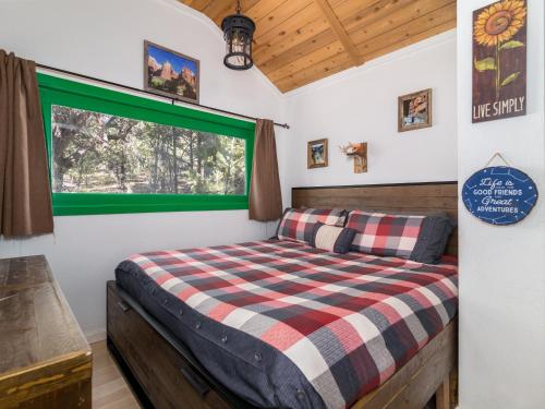 a bedroom with a bed and a window at Live Simply Cabin, Walking distance to East Zion trails in Orderville