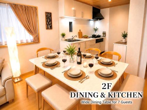 a dining room table with chairs and wine glasses at 関口ロイヤルハウス in Tokyo