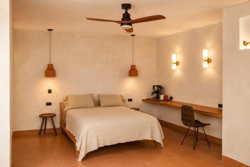 a bedroom with a bed and a ceiling fan at Ciruelo Tuyo in La Paz