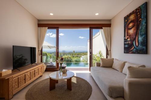 a living room with a couch and a tv at 1BR Ocean View Villa with Private Pool - Bingin in Bingin Beach