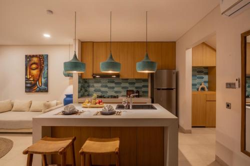 a kitchen with a kitchen island with two chairs at 1BR Ocean View Villa with Private Pool - Bingin in Bingin Beach
