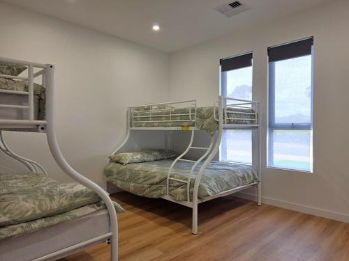 a room with two bunk beds and a window at Belless at Moonta Bay in Port Moonta