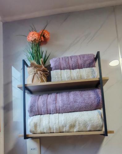 a bunch of towels are on a shelf at Julieta House in Puerto Natales