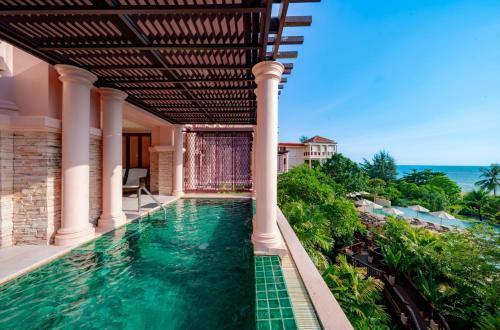 a swimming pool in a house with a view of the ocean at Centara Grand Beach Resort Phuket in Karon Beach
