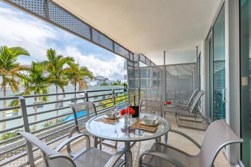 a balcony with a table and chairs and a view of the ocean at SBV Luxury Ocean Hotel Suites in Miami Beach
